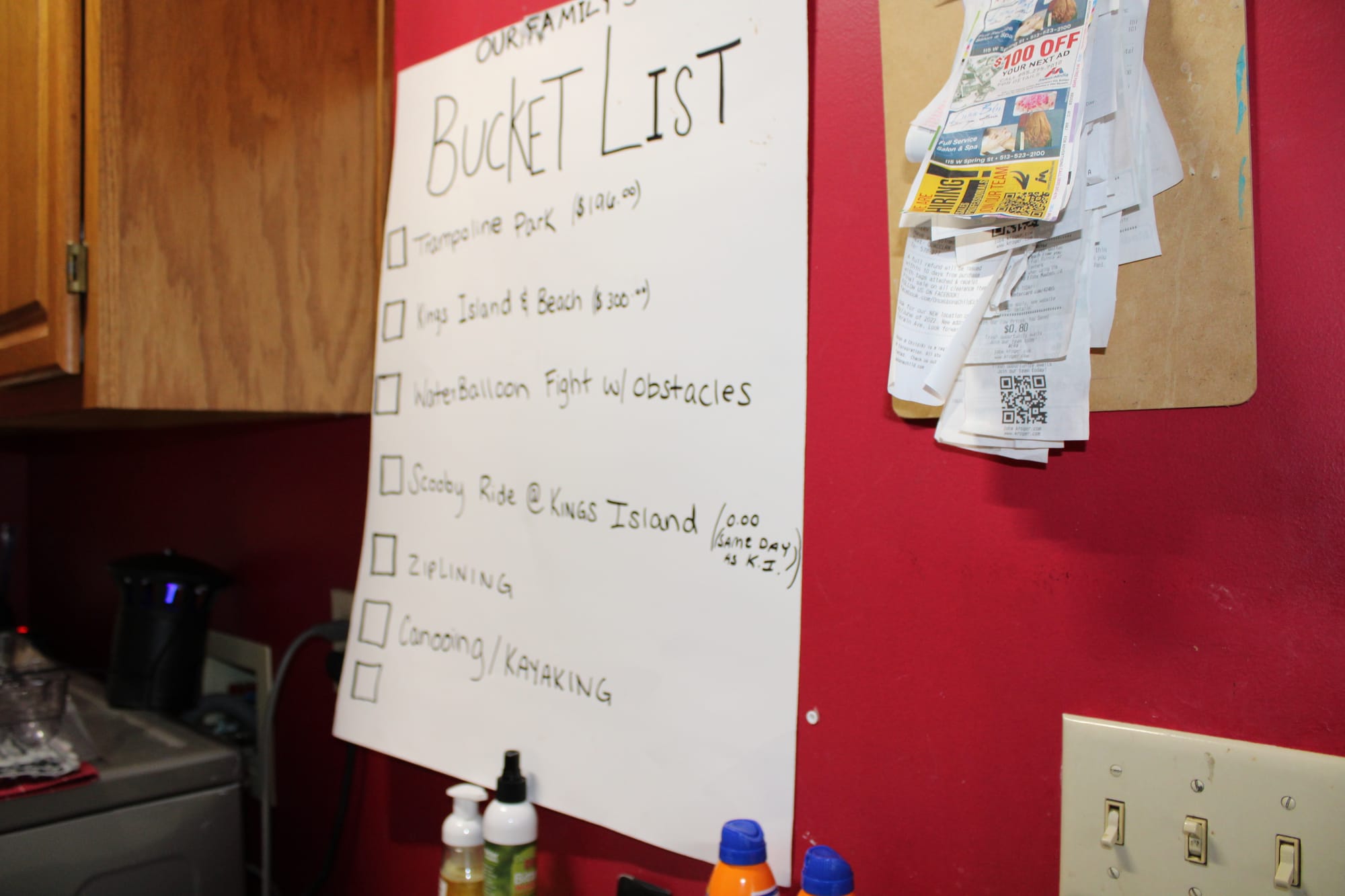 A large sheet of paper labeled "bucket list" hangs in a laundry room