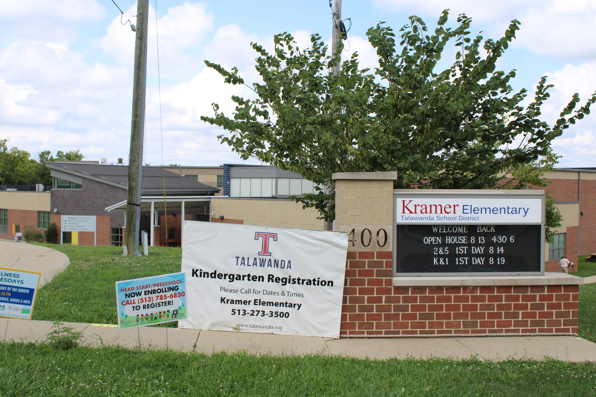 Signs outside Kramer Elementary advertise open house and registration times