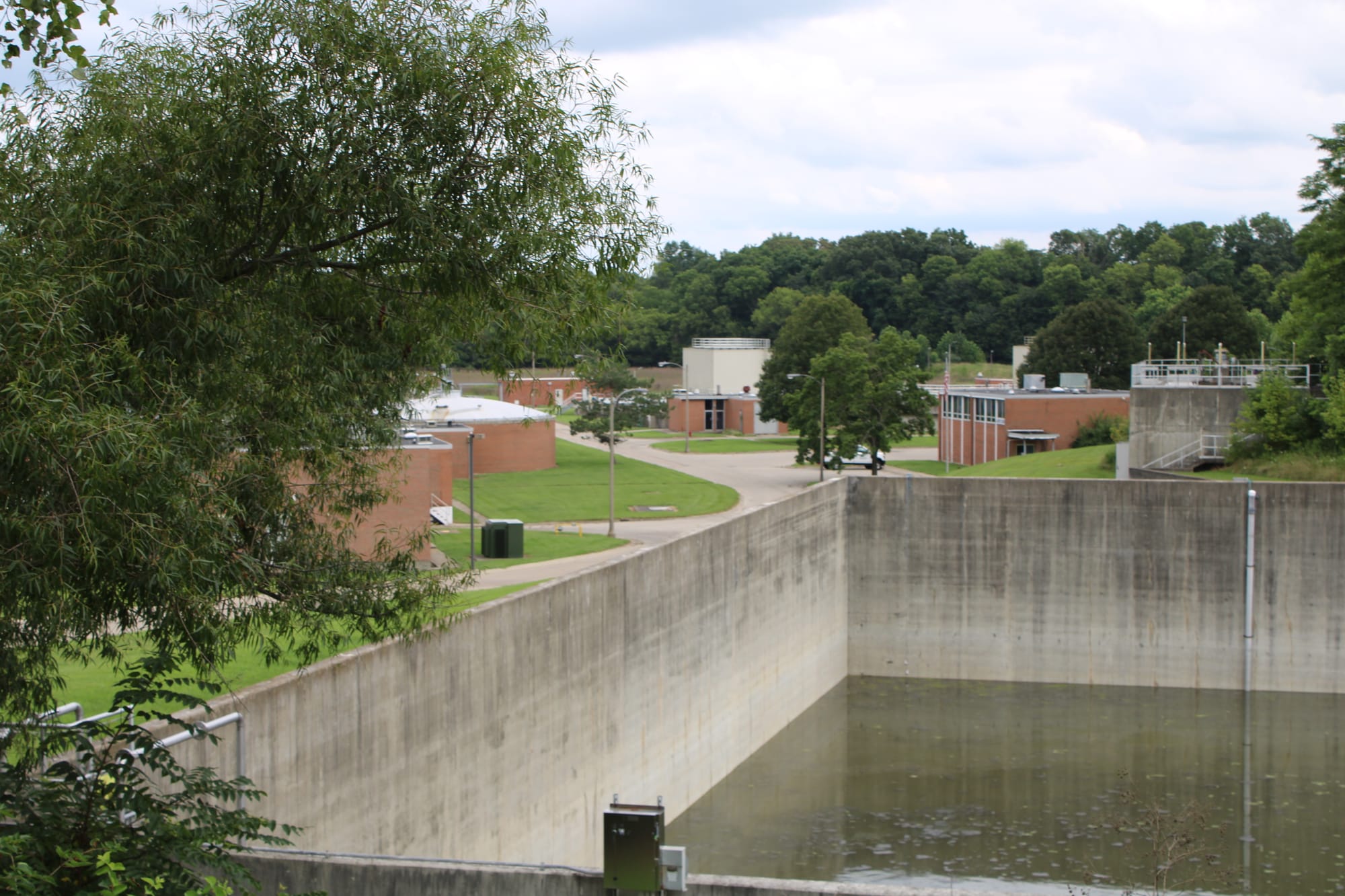 A large concrete basin with water at the bottom, outside of Oxford's water treatment plant