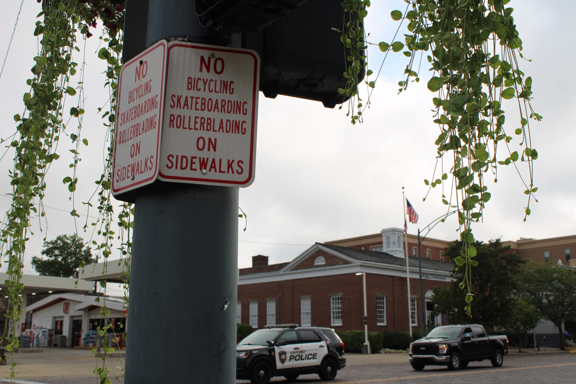 A sign with red text reading "No bicycling, skateboarding, rollerblading on sidewalks"