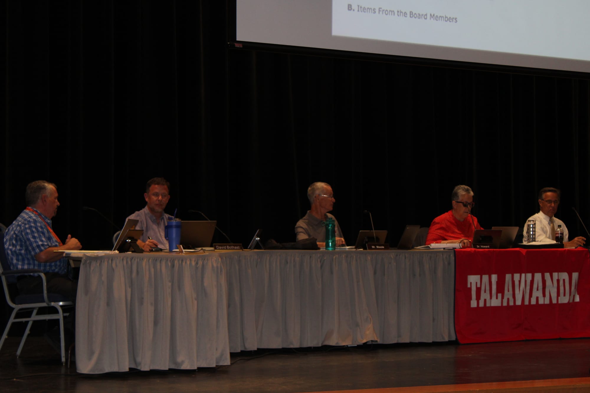 Talawanda board members sit behind a table on stage