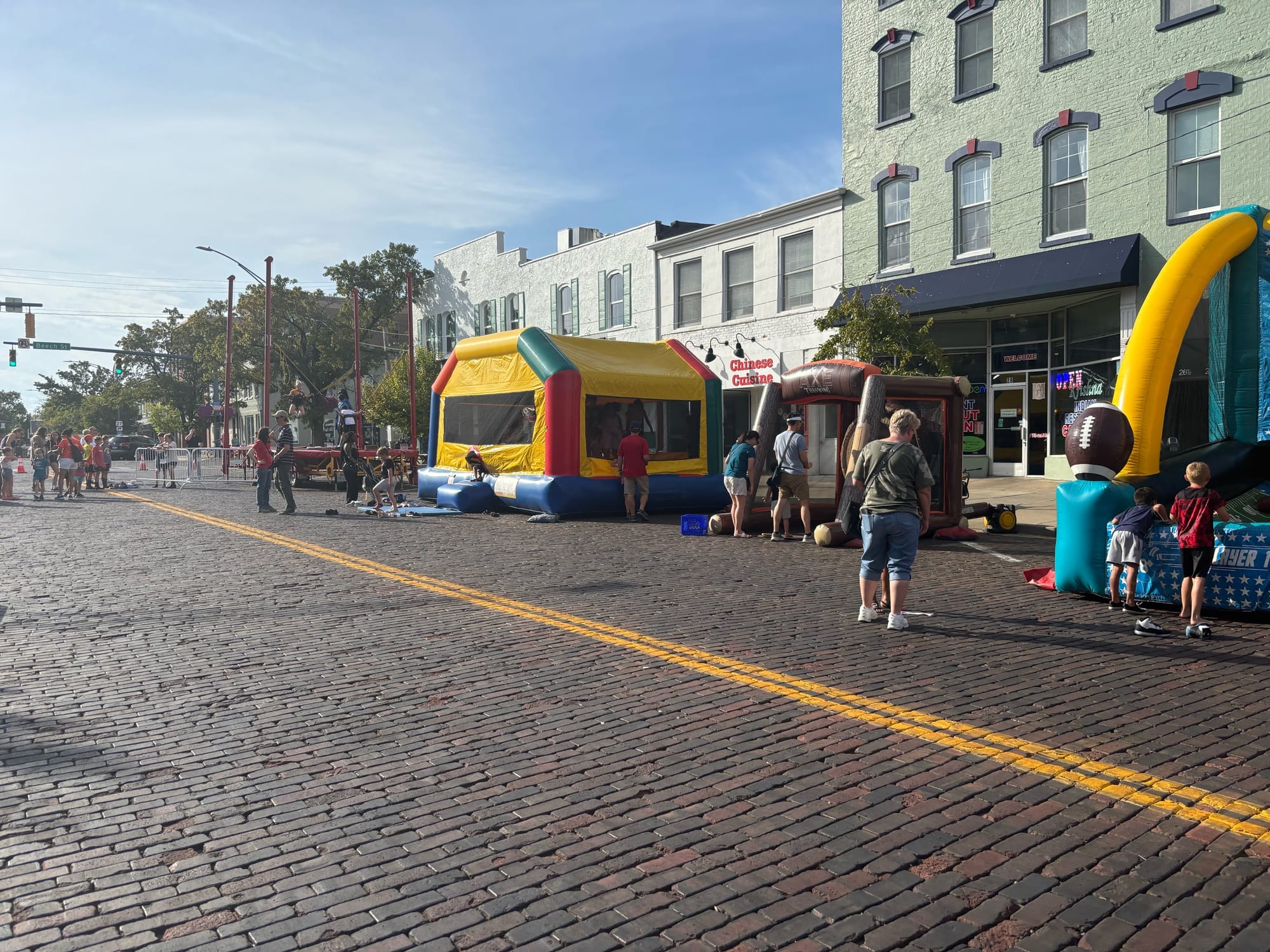 Kids and families gathered around different inflatables on High Street