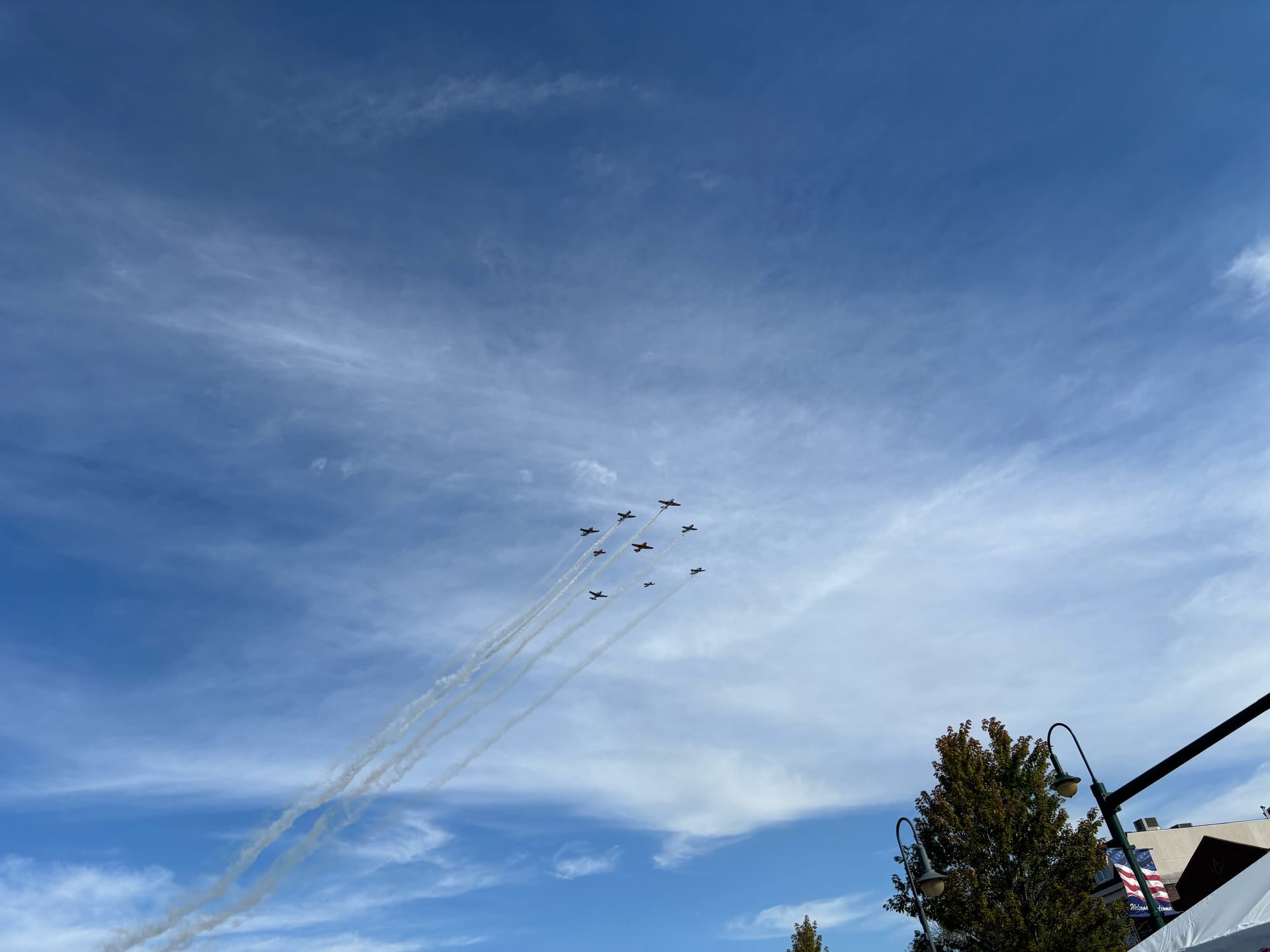 A view of nine planes flying over Uptown