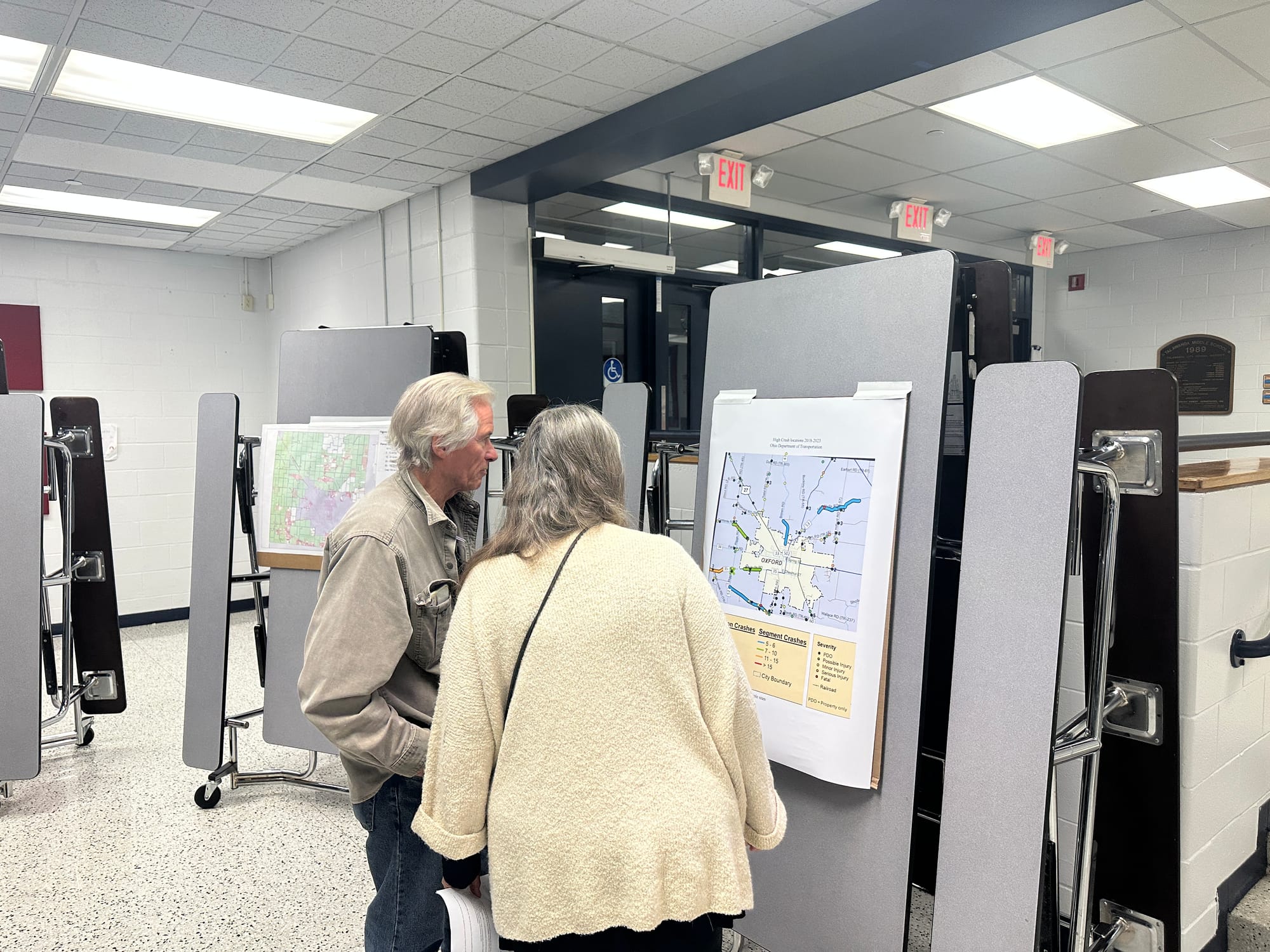 Two residents look at a map showing crash points in Oxford Township