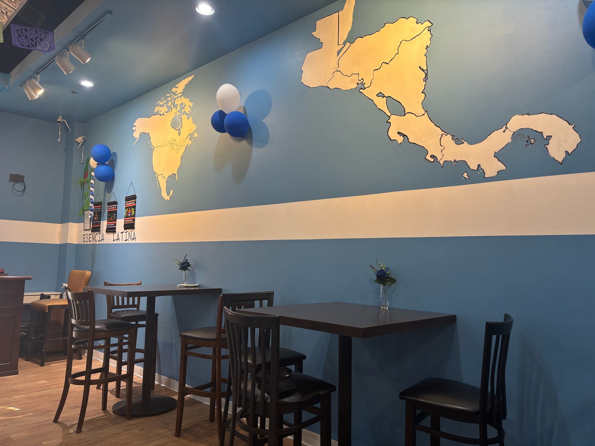 A view of different Latin American countries on a blue background alongside balloons