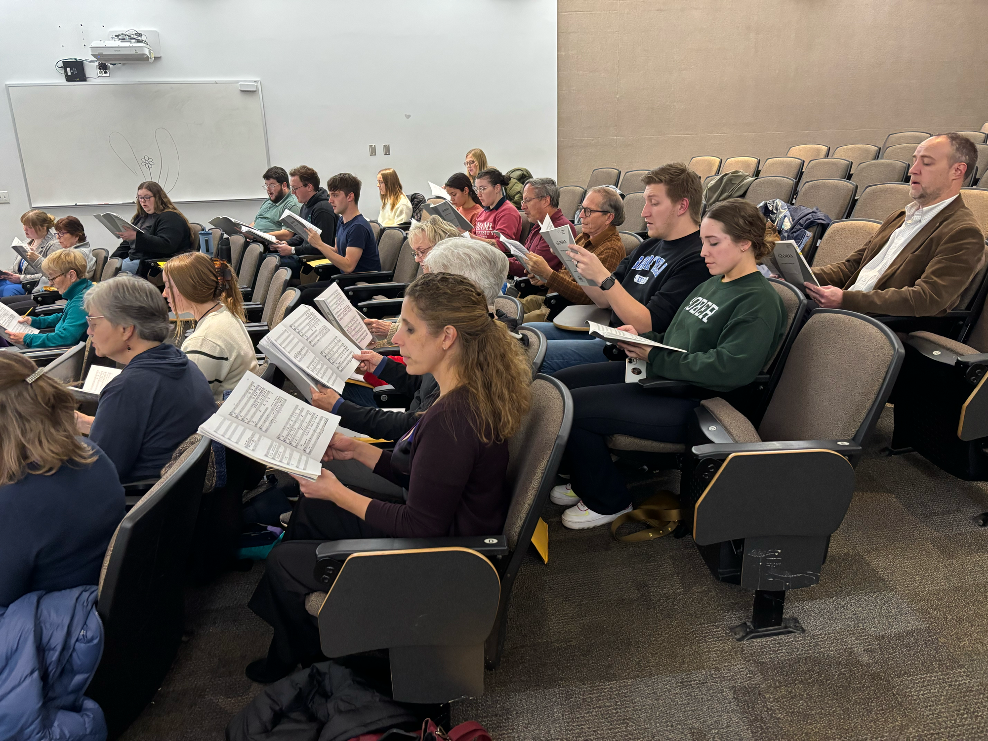 The choir rehearsing for their upcoming concert.