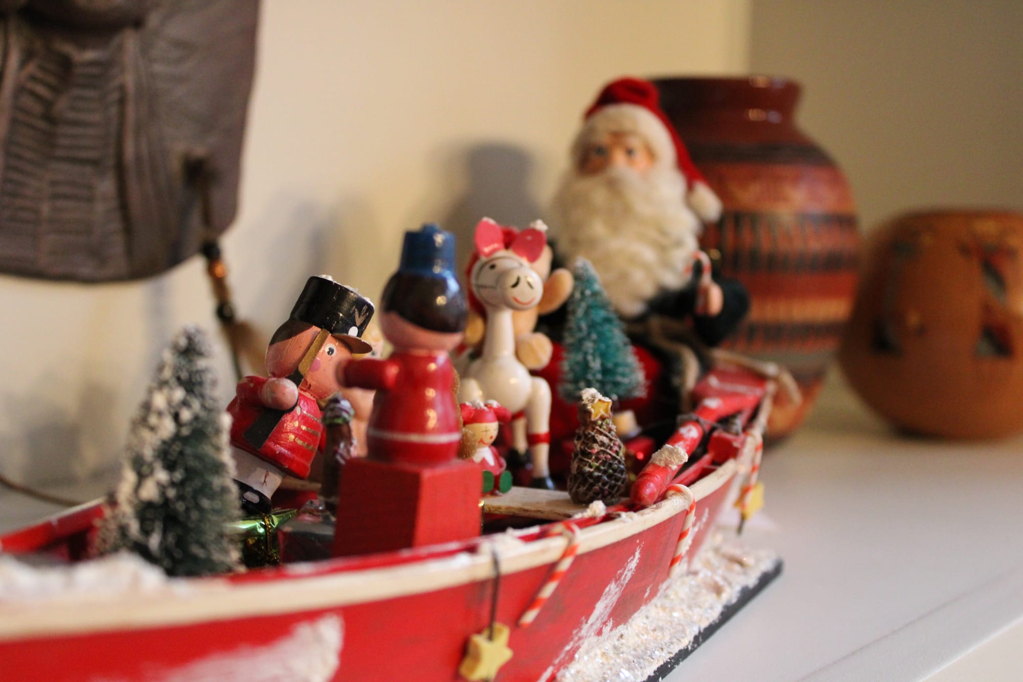 A miniature decorative boat filled with Christmas characters