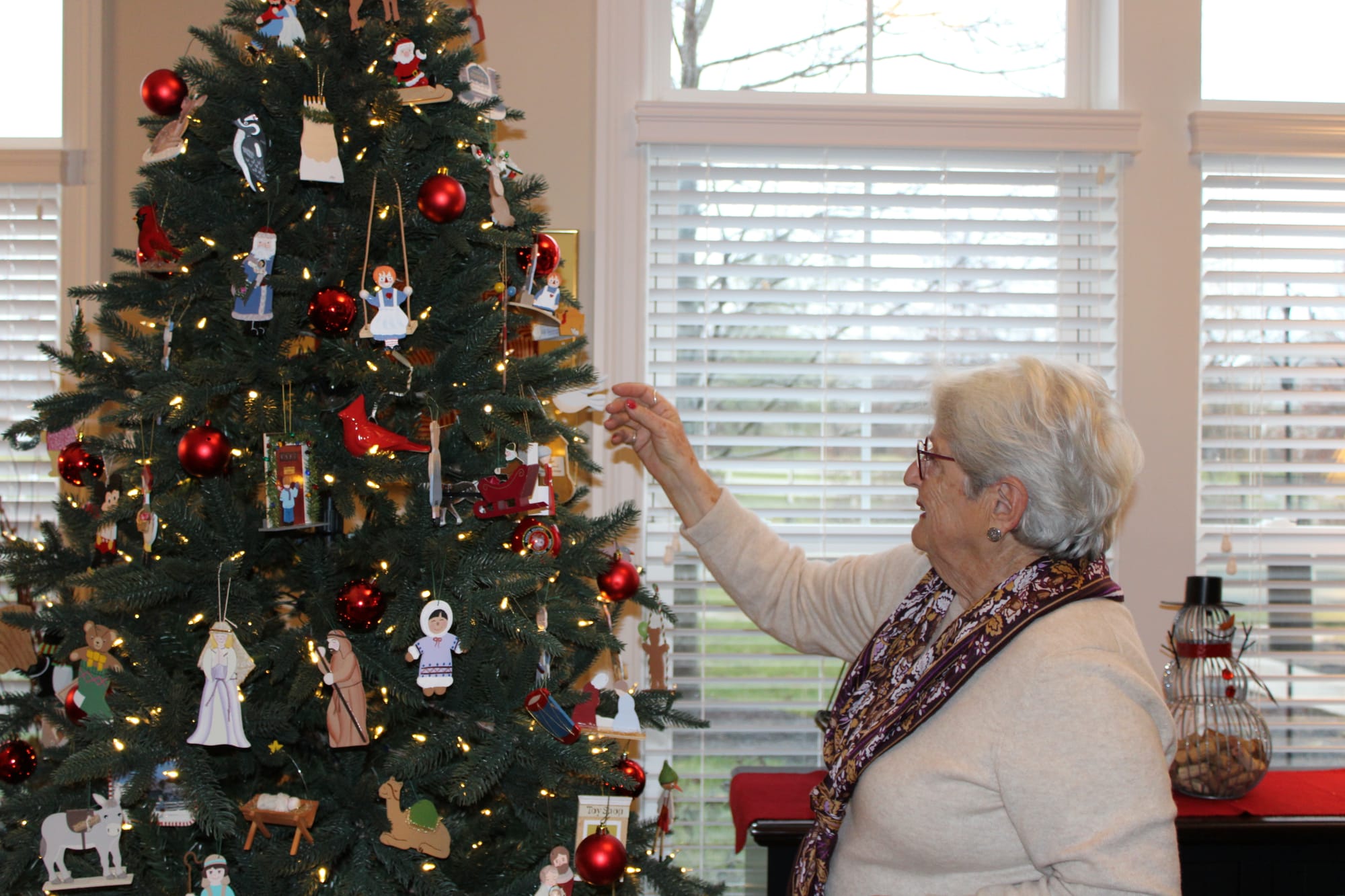 Pat Gifford looks at the Barker ornaments covering her Christmas tree