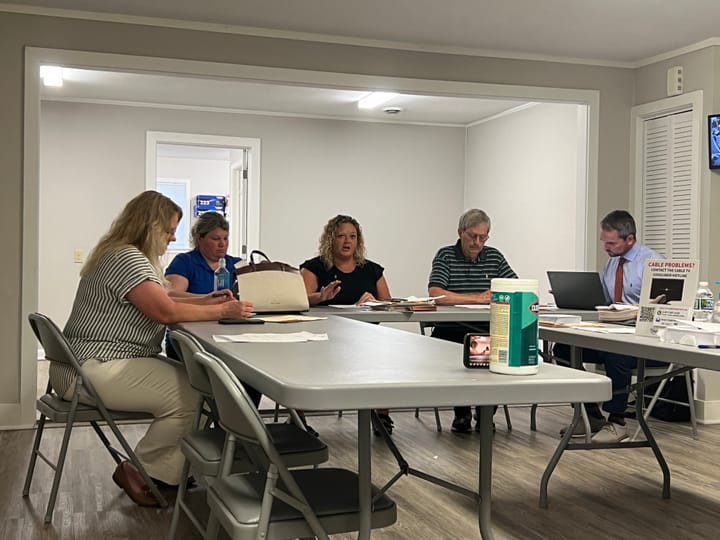 Ann McCoy, Danyell Bolser, Molly Cason, Mike Ruther and Nick Ziepfel sit at fold-out tables in a meeting room