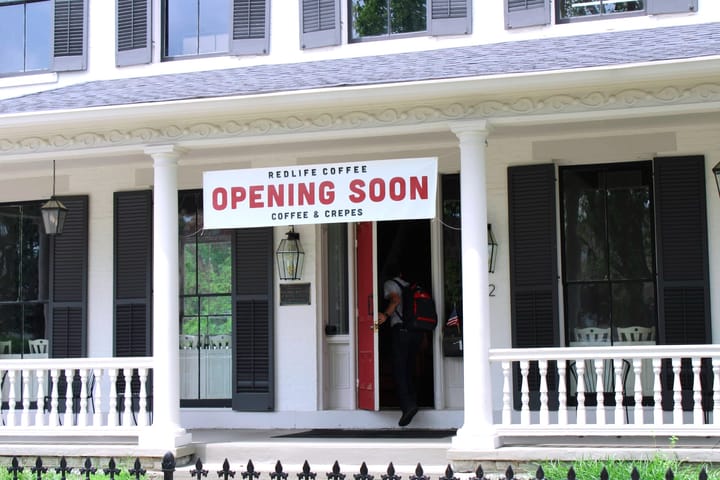 RedLife Coffee has renovated a white two story house to hold their coffee shop and church.