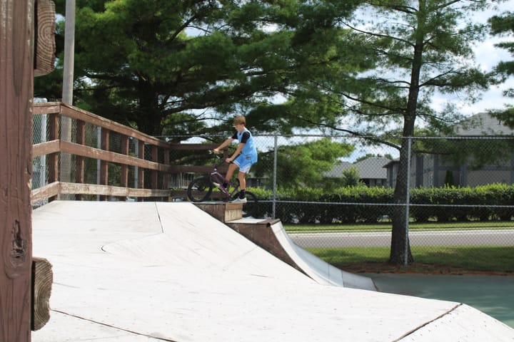 A young biker rides up a ramp at the Oxford skatepark