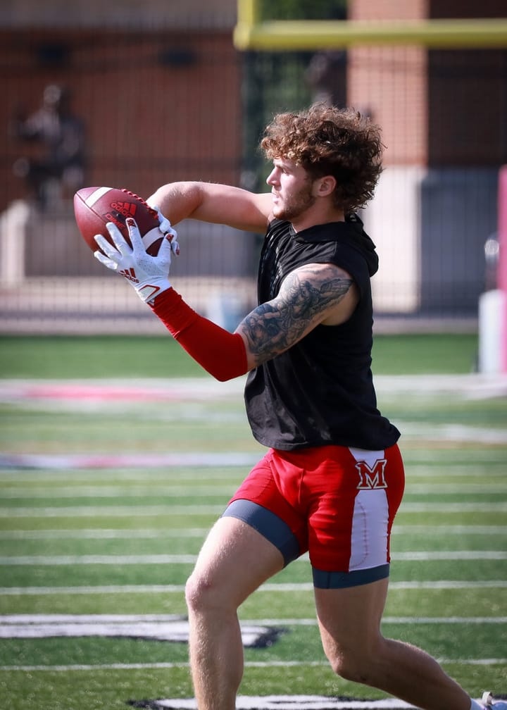 A football player runs with the ball