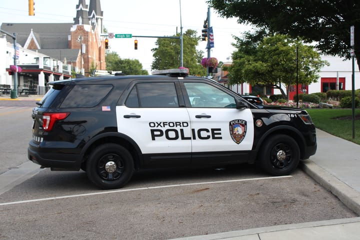 An Oxford Police Department cruiser parked outside of the police department