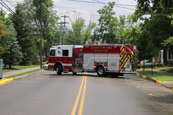 A firetruck parks across the yellow line on Campus Avenue