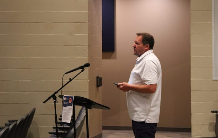 Ivan Carver stands in front of a microphone