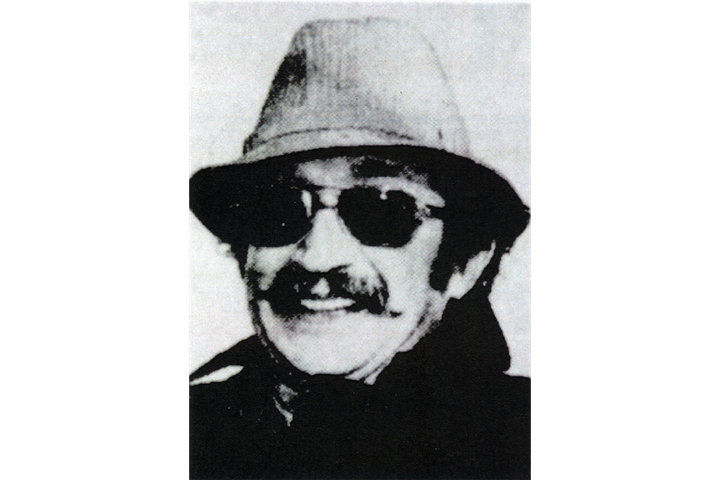 A black and white archive photo of Jack Samuelson in a hat and sunglasses