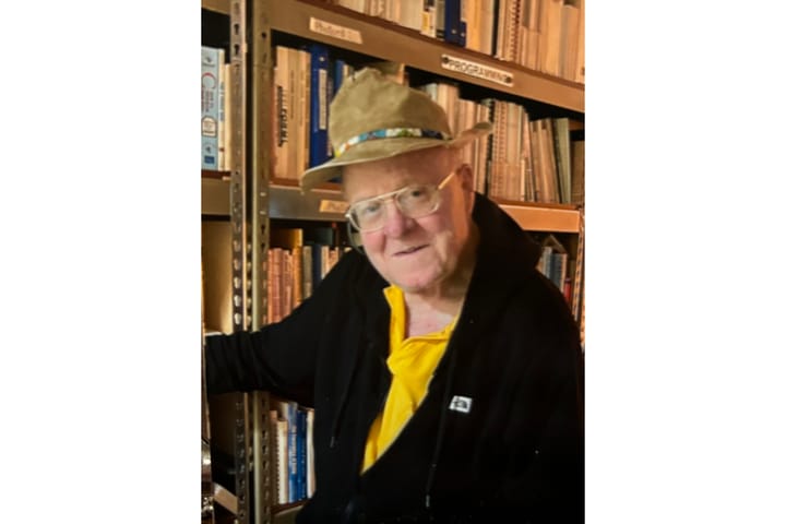 David Frank Simmons wearing a hat and yellow shirt