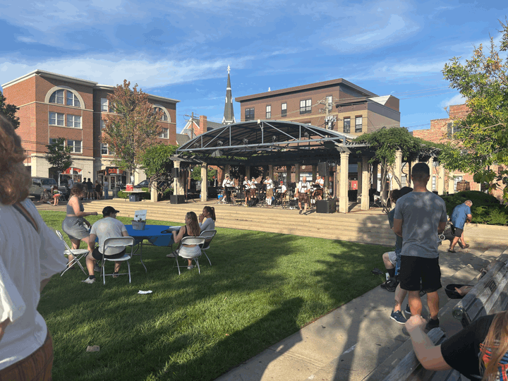 Oxford citizens and college students gathering around the pavillion to enjoy the live music