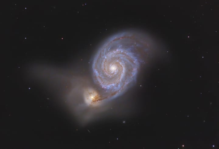 Photo of the Whirpool Galaxy, a glowing spiral in a sky full of stars