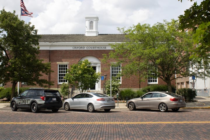 Cars parked in front of the Oxford Courthouse