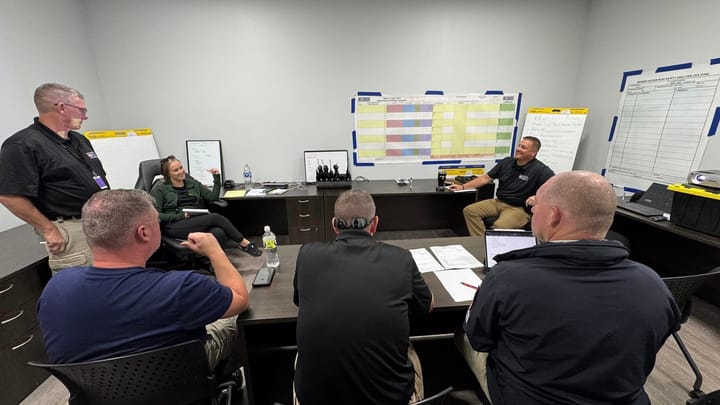 Several first responders sit around a conference table