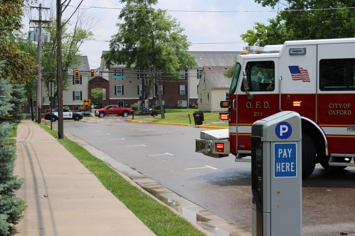 A firetruck parks across the yellow line on Campus Avenue