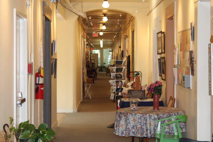 A third-floor hallway in the Oxford Community Arts Center filled with colorful furniture and art