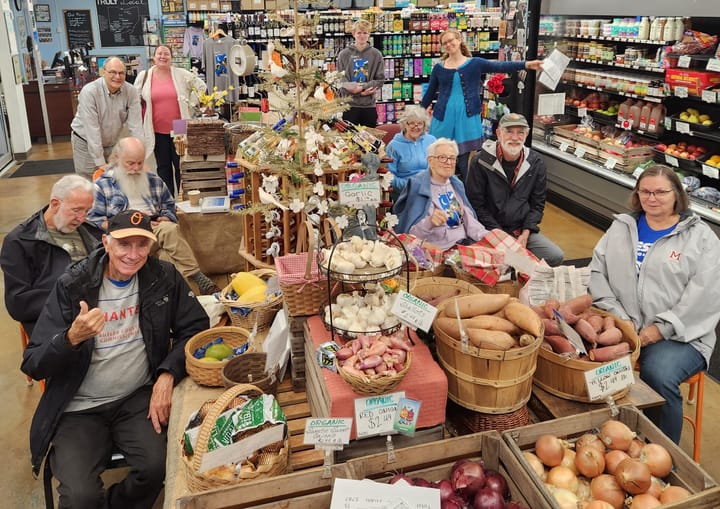 Several people sit in MOON Co-op and smile