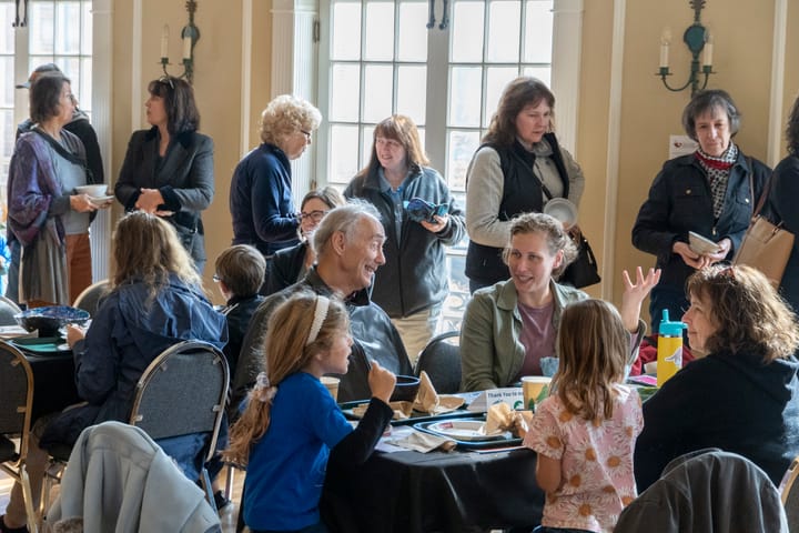 People sit down to eat in the Oxford Community Arts Center at an Empty Bowls event