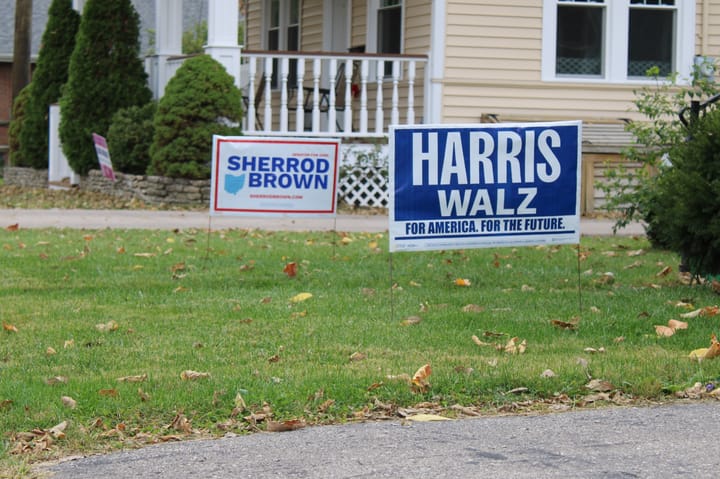 Yard signs for Sherrod Brown in Kamala Harris in a front yard