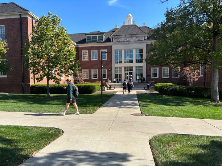 Miami students walking across Miami's campus in between classes