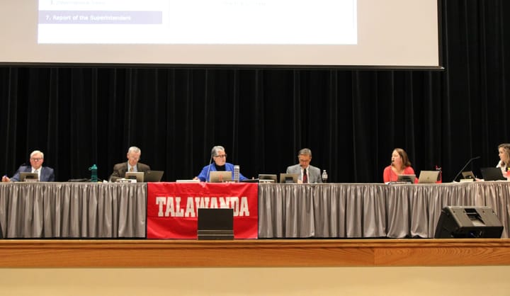 Talawanda board members sit behind a table on stage