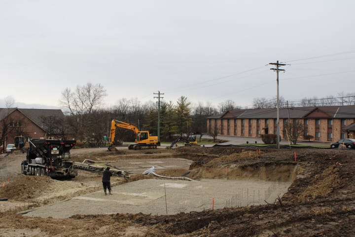 A construction site with Best Western in the background