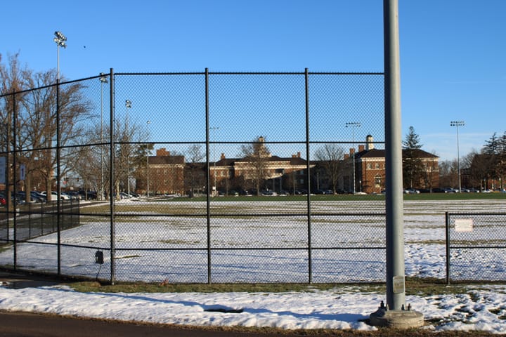 Farmer School of Business seen through a fence from across Cook Field