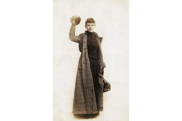 Black and white photo of Nellie Bly in a long checkered coat