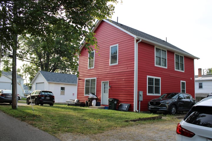 A red house on an alley lot