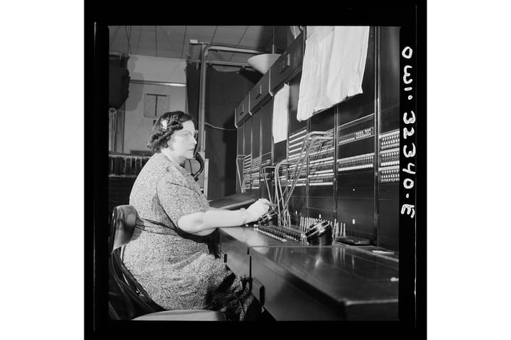 A black and white photograph of a telegraph operator