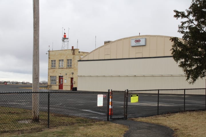 Oxford airport hangar seen beyond a fence