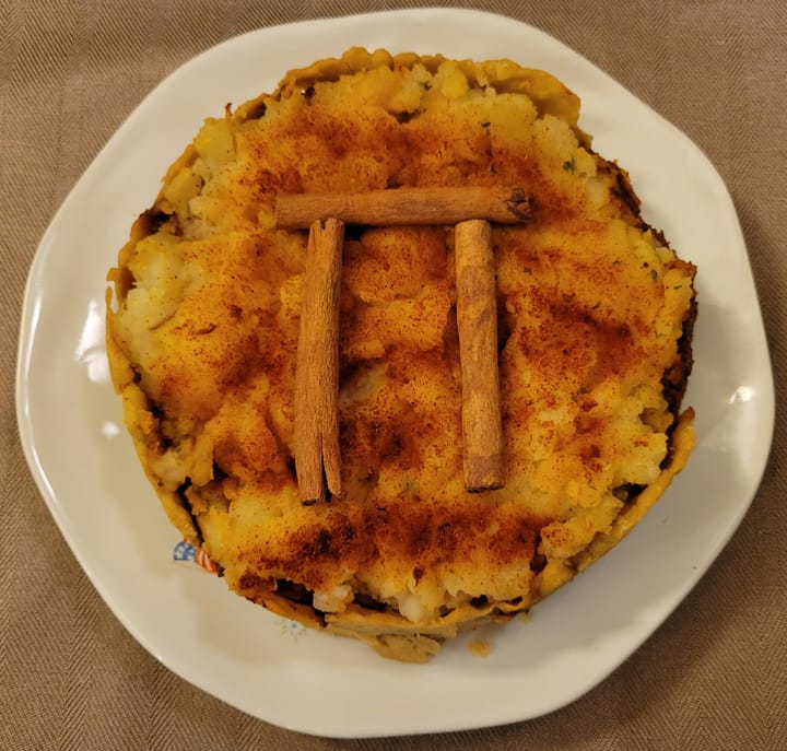 Shepherd's pie with cinnamon sticks arranged in the shape of pi on top